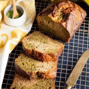Slices of matcha banana bread next to half a loaf.
