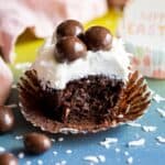 A half eaten chocolate coconut cupcakes.