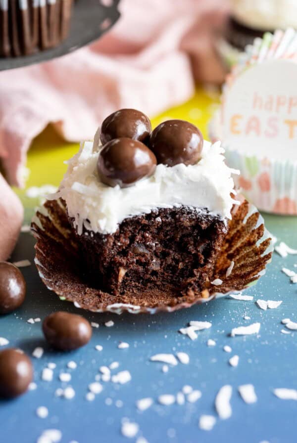 A half eaten chocolate coconut cupcakes.