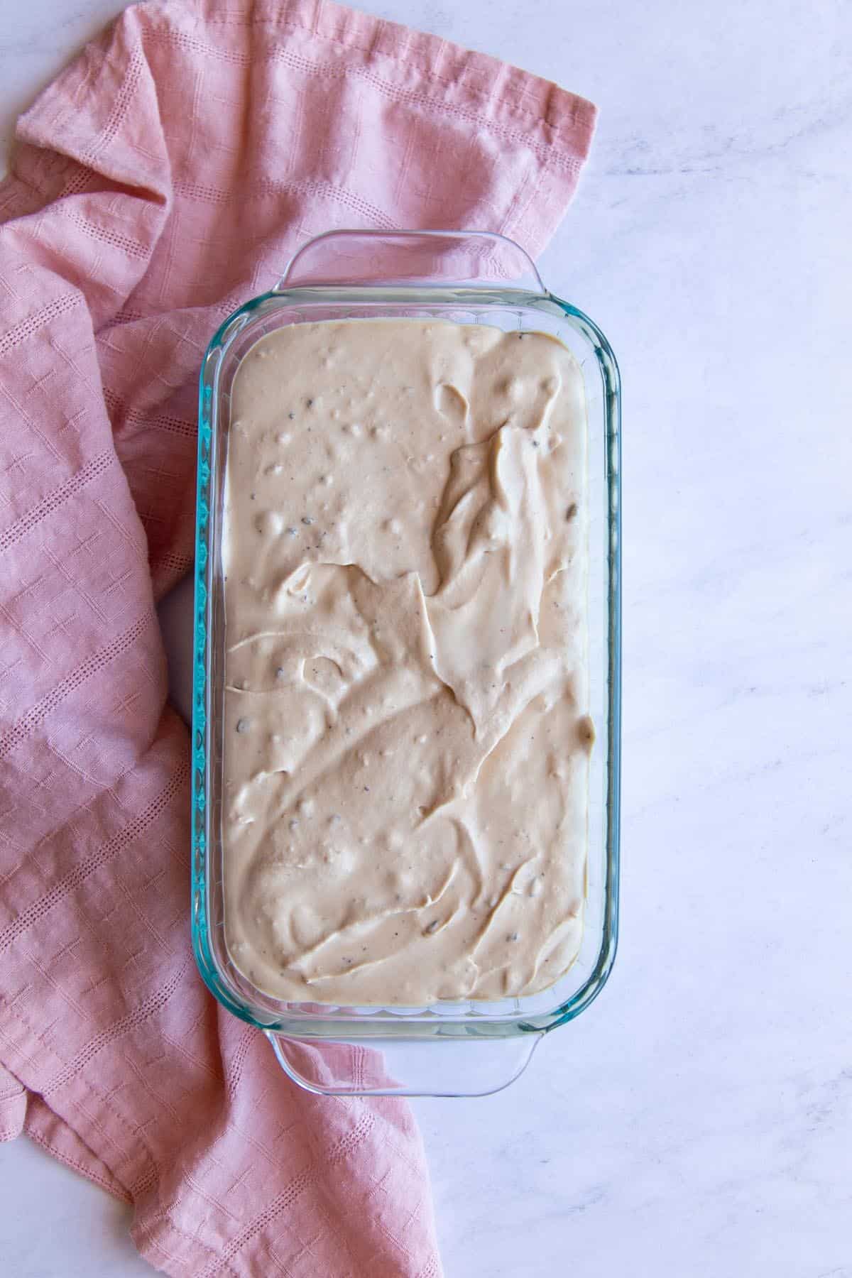 Frozen coffee macadamia ice cream in a glass loaf pan.