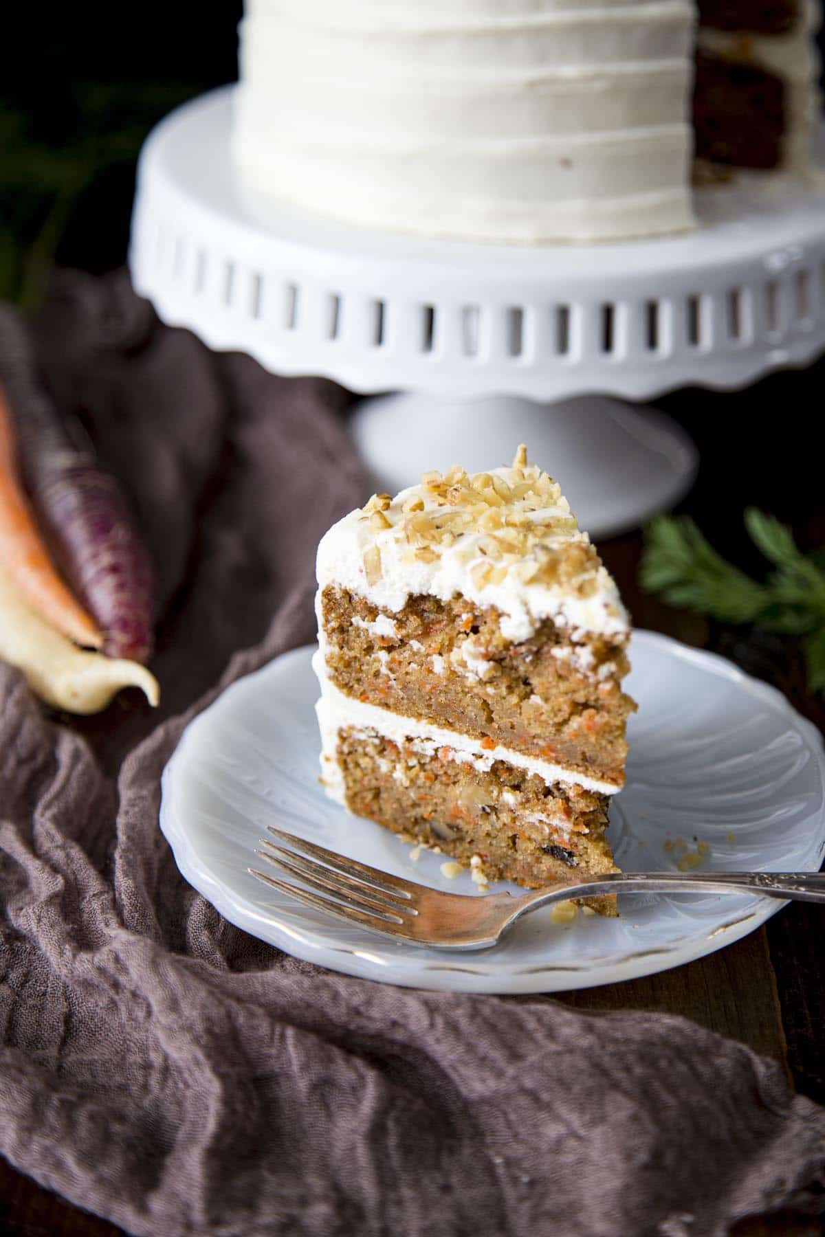 A slice of mini carrot cake on a white plate.