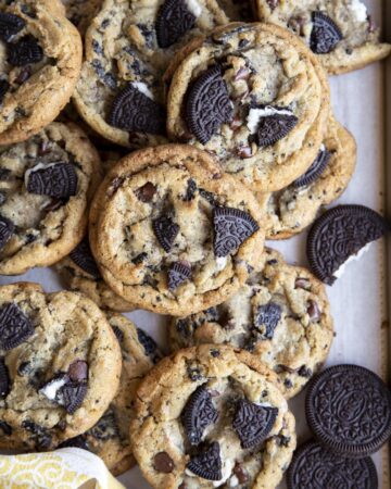A pile of Oreo chocolate chip cookies inside a baking tray.