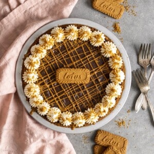 A Biscoff cookie butter pie on a gray table top next to a pink towel.