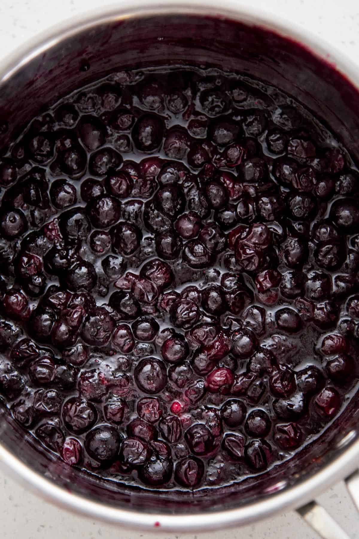 A pot of cooked blueberry compote for blueberry pie filling.