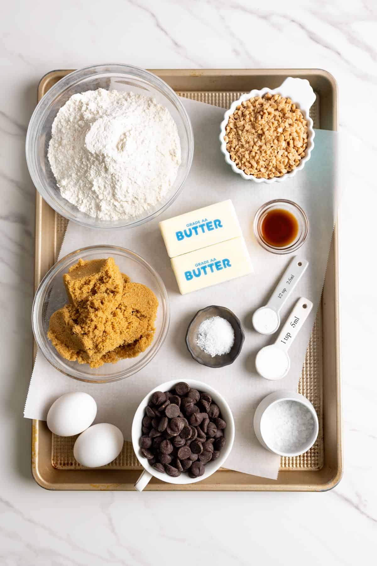 Brown butter toffee chocolate chip cookies ingredients on a baking tray.