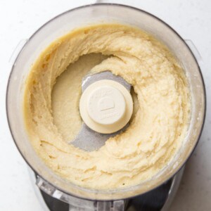 Almond frangipane in the bowl of a food processor.