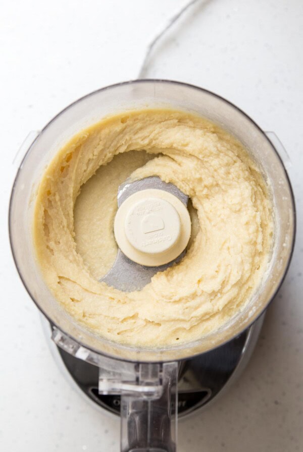 Almond frangipane in the bowl of a food processor.