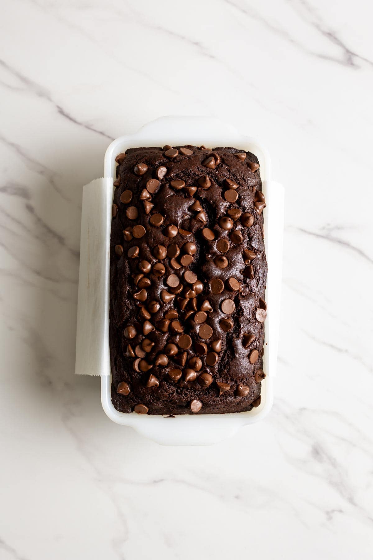 Baked chocolate bread in a loaf pan.