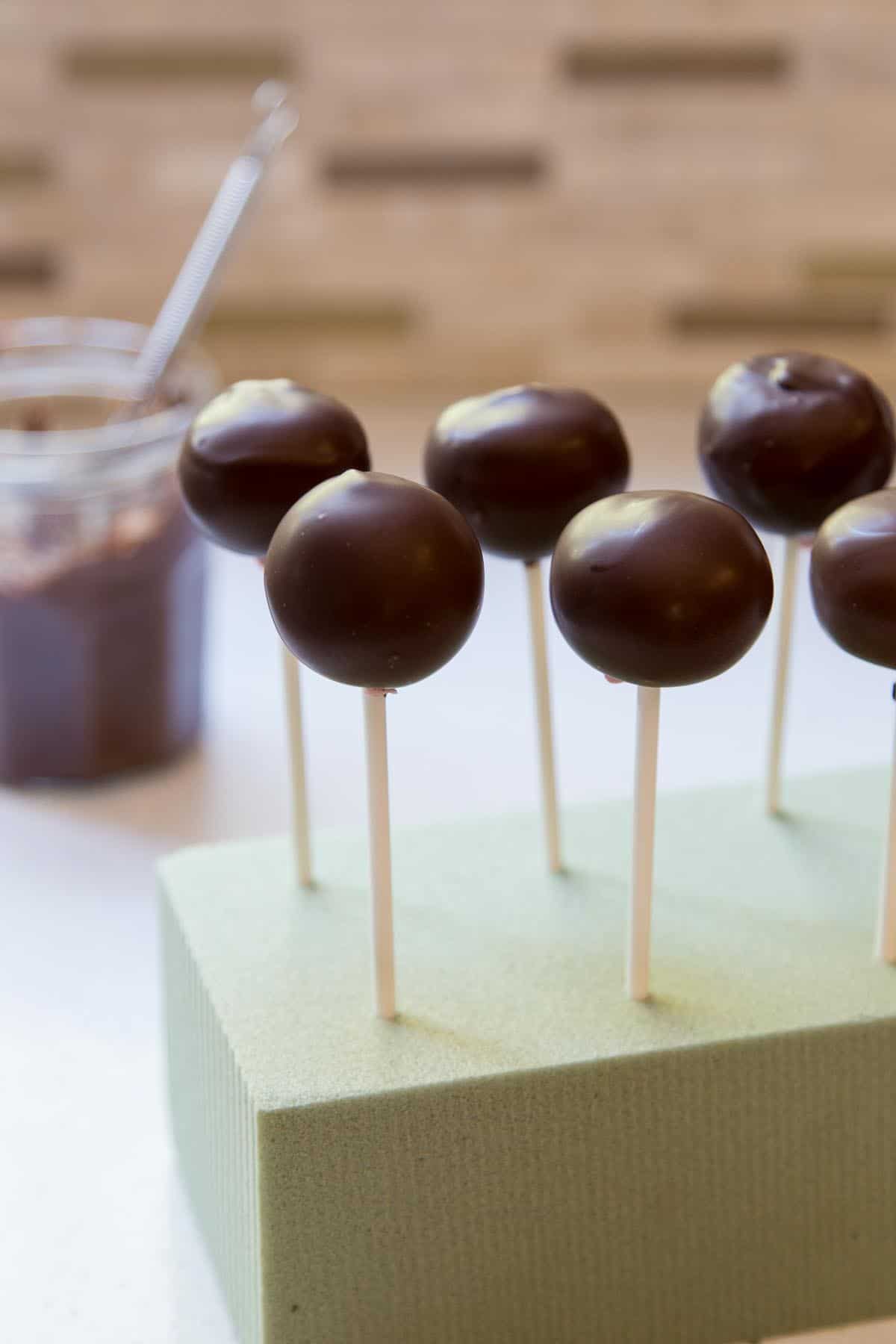 Drying strawberry truffles on a block of floral foam.