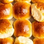 Top view of a batch of coconut milk bread dinner rolls.
