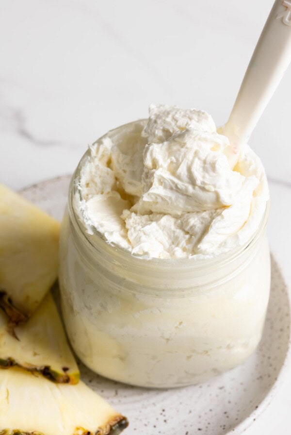Pineapple frosting in a glass jar.