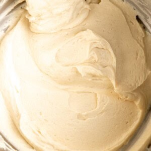 Brown butter cream cheese frosting inside a metal bowl.