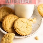 Closer view of three macadamia cookies on a plate with a bottle of milk.