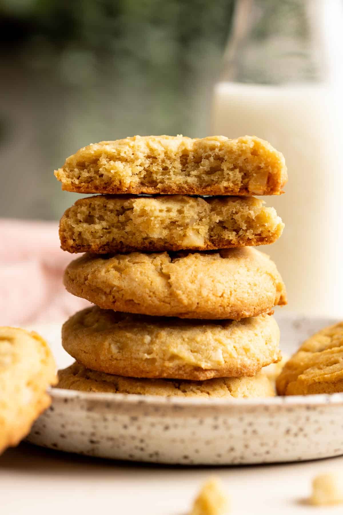 A stack of macadamia nut cookies, the top two are halves.