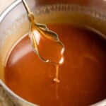 A spoonful of miso caramel drizzling into a pan.