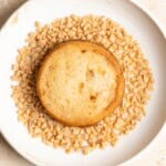 A miso toffee shortbread cookie in a plate with toffee bits.