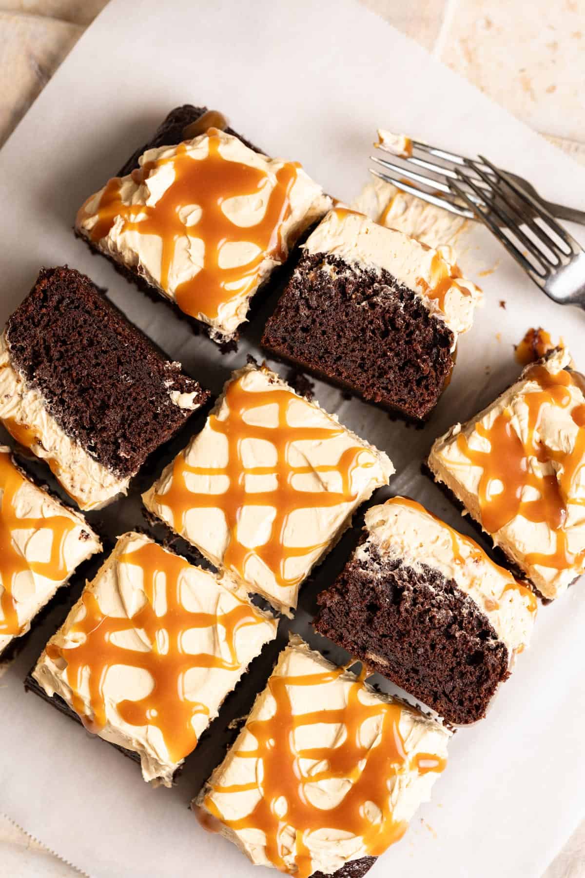 Slices of chocolate banana cake with miso caramel frosting with some slices tipped on their sides.