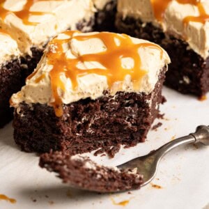 A half eaten slice of chocolate banana cake with miso caramel frosting and drizzle.