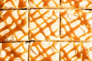 Miso caramel drizzles on top of sliced frosted cake.