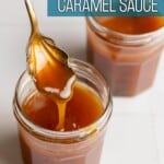 Coconut milk caramel sauce falling off a spoon into a glass jar.