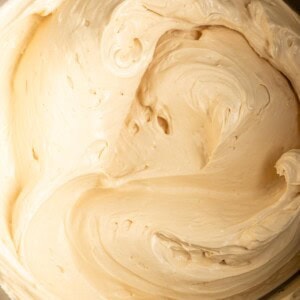Miso caramel frosting inside a stand mixer bowl.