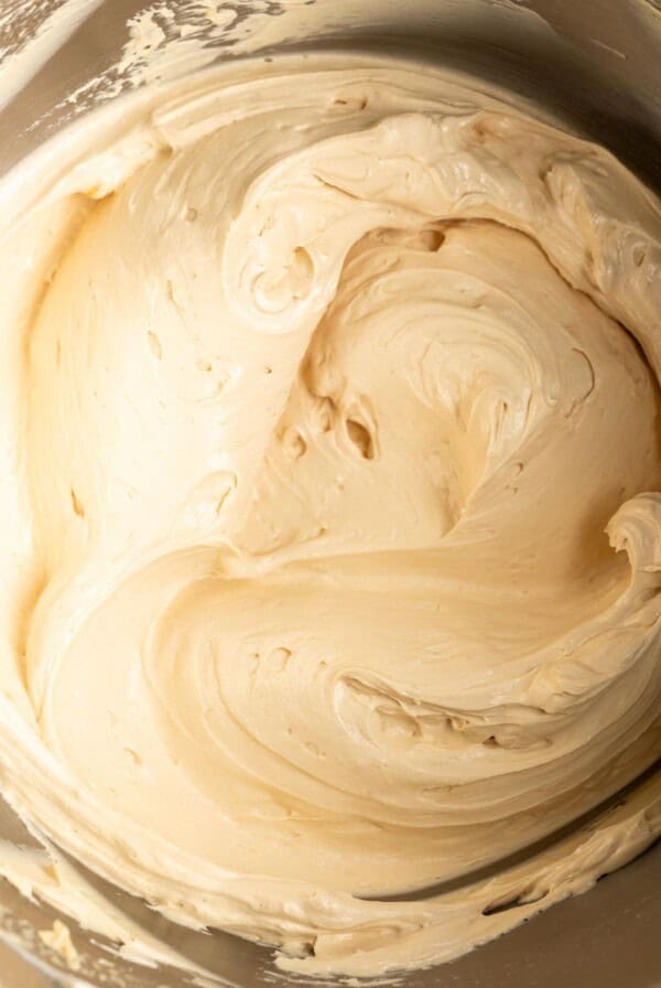 Miso caramel frosting inside a stand mixer bowl.
