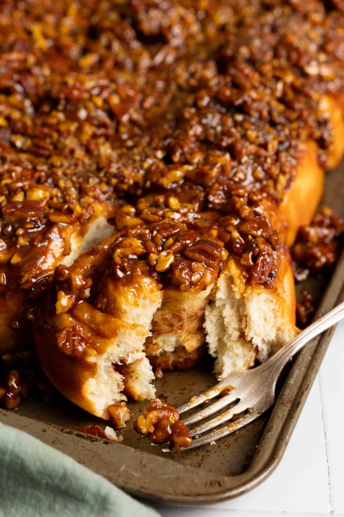A pecan roll cut open showing the soft fluffy interior.