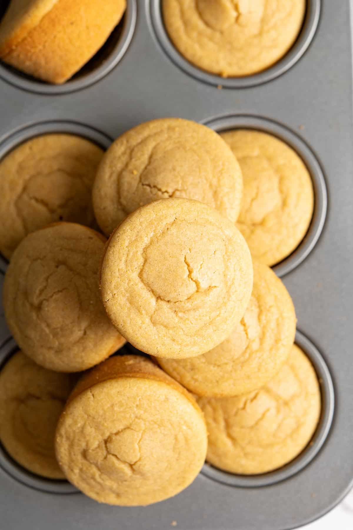 A pile of mochi cornbread on top of a muffin pan.