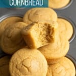 A mochi cornbread muffin half eaten sitting on top of others.