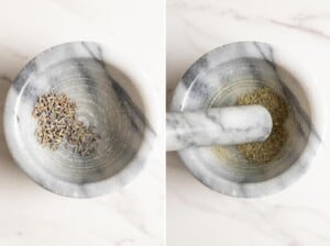 Grinding dried lavender flowers with a pestle and mortar.