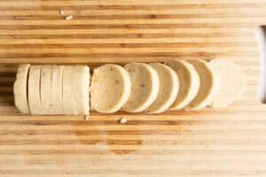 Sliced macadamia nut shortbread cookie dough.