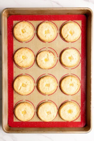 Baked pineapple shortbread on a lined baking sheet.