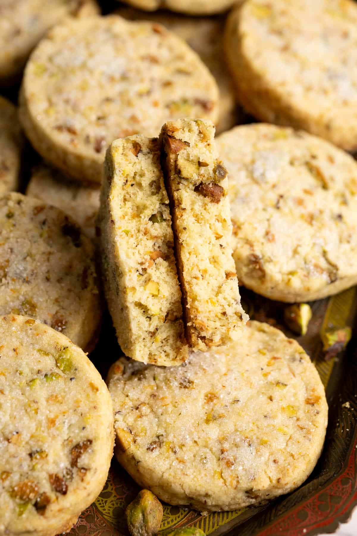 A pistachio cookies broken in halves to show the interior texture.