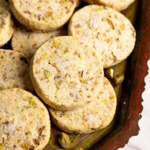 Pistachio shortbread cookies on a tray.