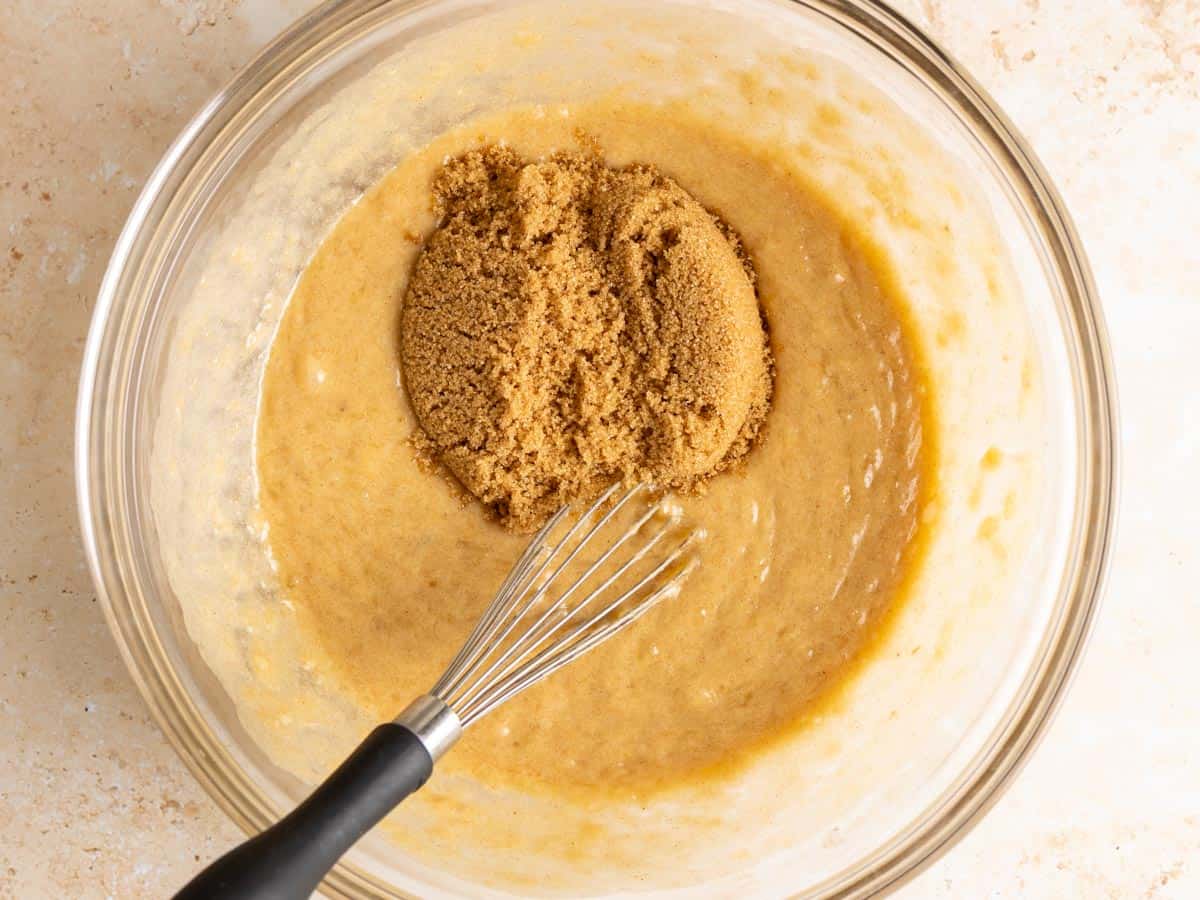 Brown sugar in a bowl with wet ingredients.