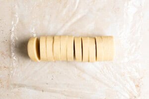 A log of shortbread cookie dough, sliced.