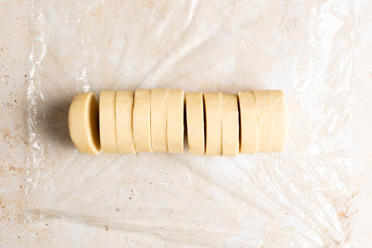 A log of shortbread cookie dough, sliced.