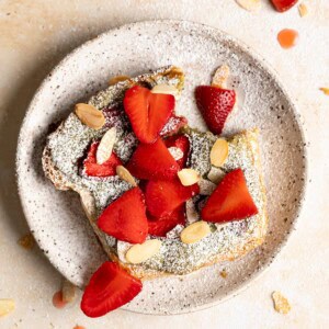 A matcha strawberry bostock on a plate.