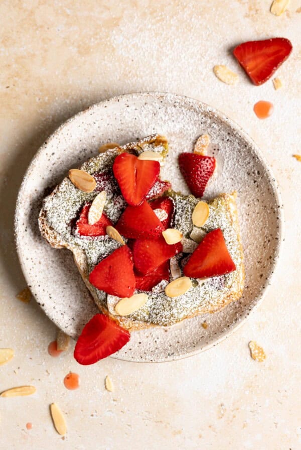 A matcha strawberry bostock on a plate.