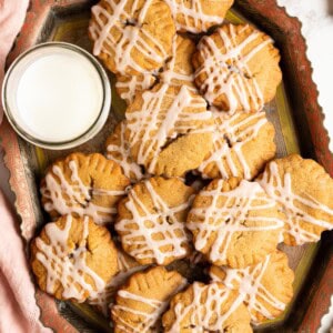A tray of miso peanut butter cookies with jam and glass of milk.
