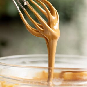Vietnamese coffee glaze dripping down from a whisk.