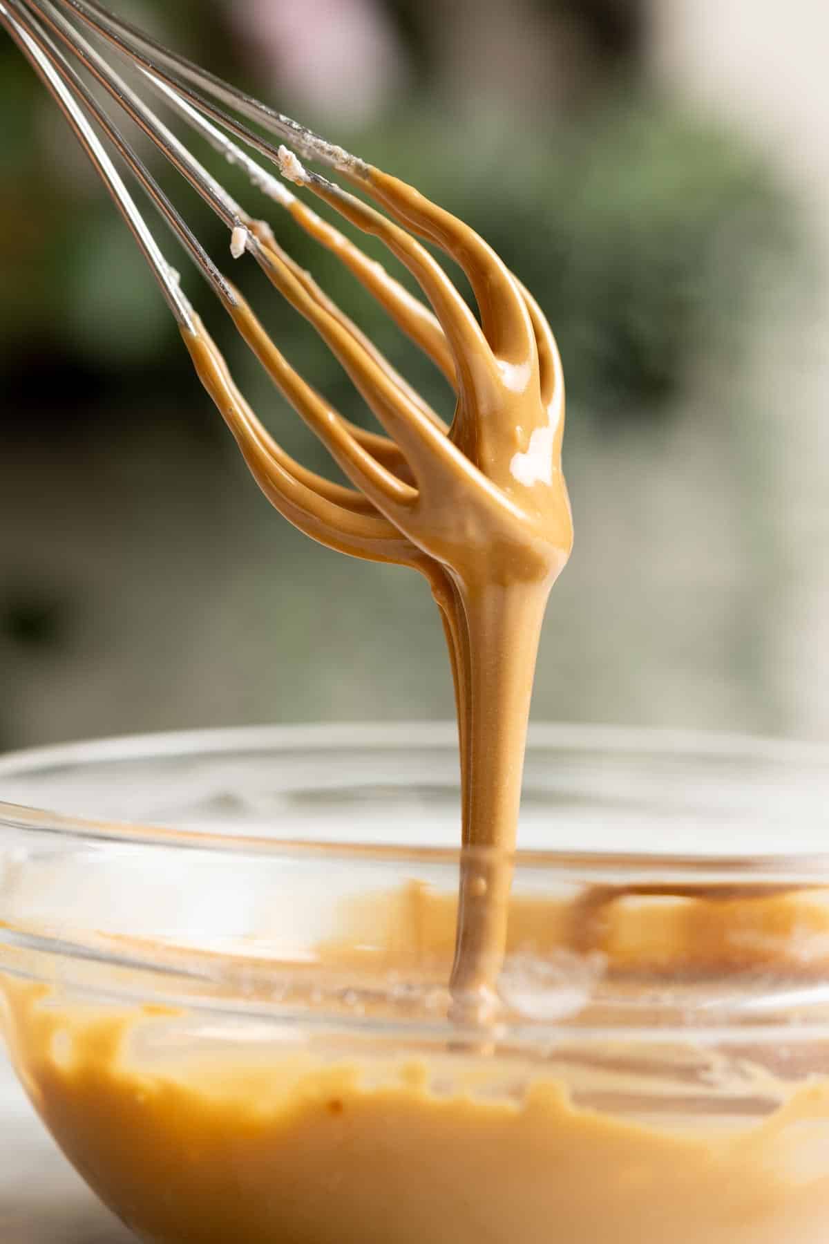 Vietnamese coffee glaze dripping down from a whisk.