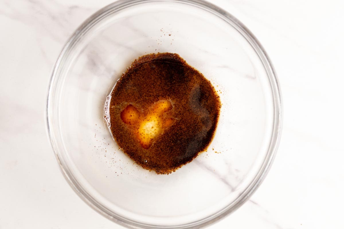 Instant espresso powder and water in a glass bowl.