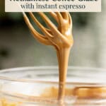 Coffee icing drizzling down from a whisk.
